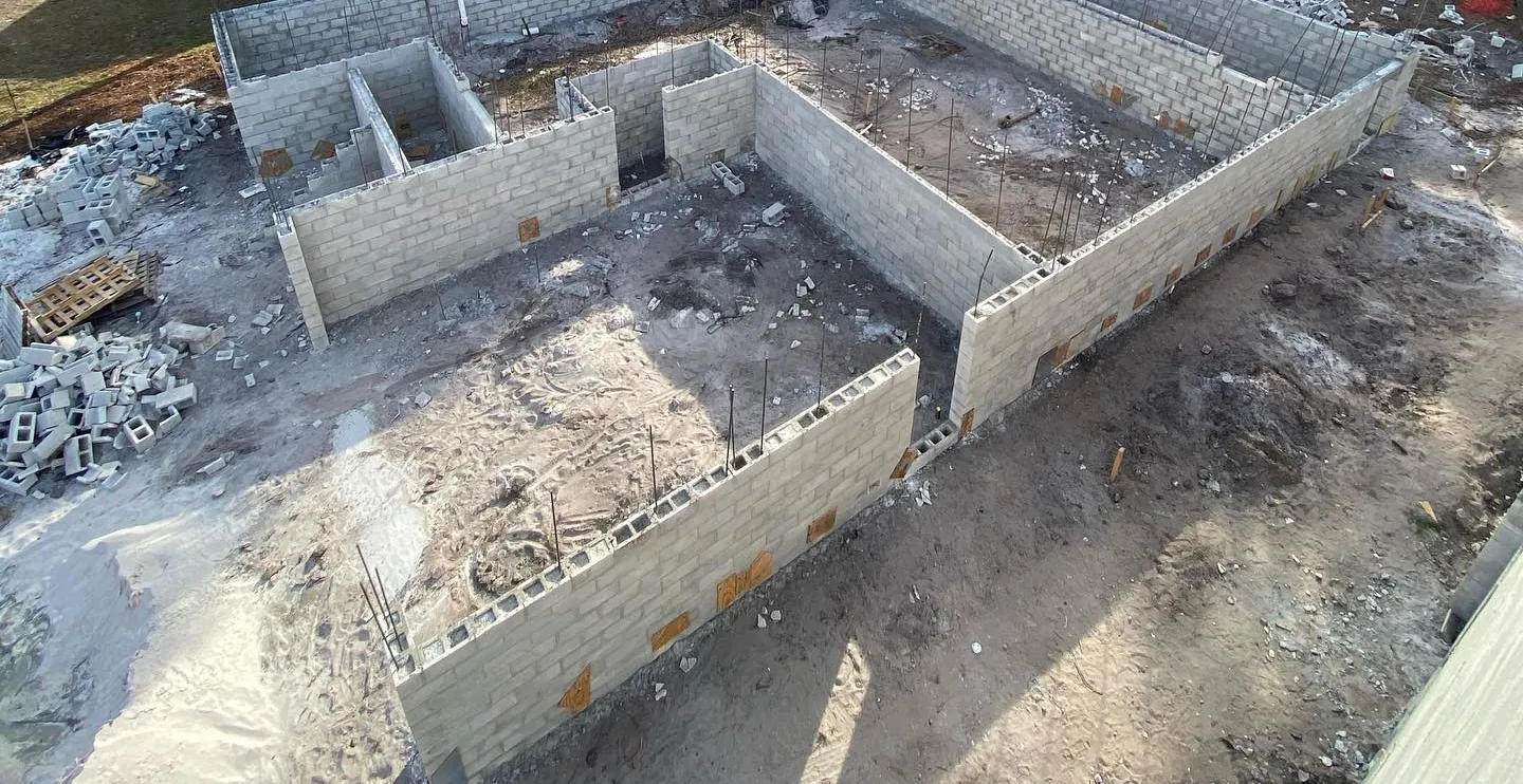 New concrete block stem walls rising on a cleared residential lot