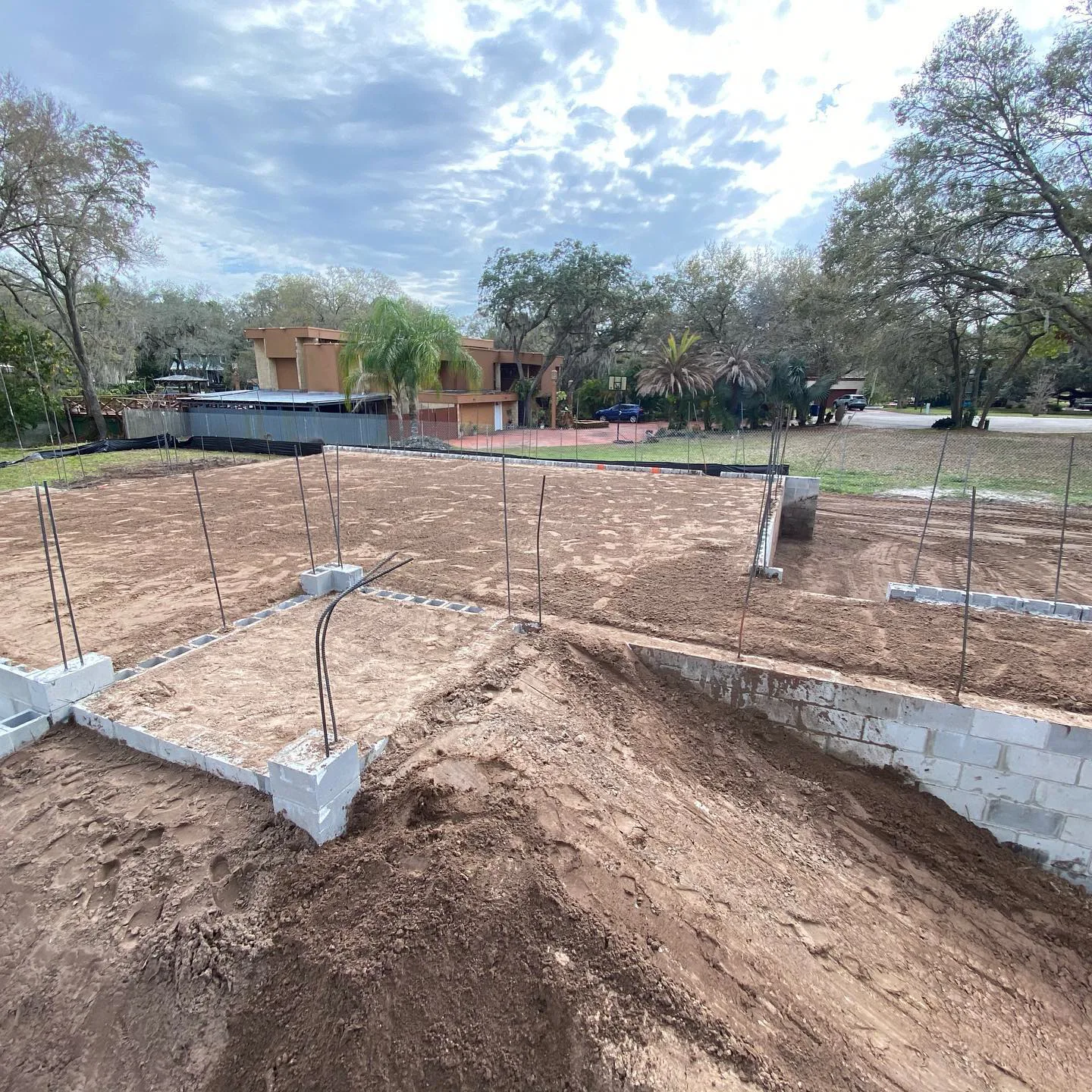 Fill placed against a block stem wall corner during pad preparation
