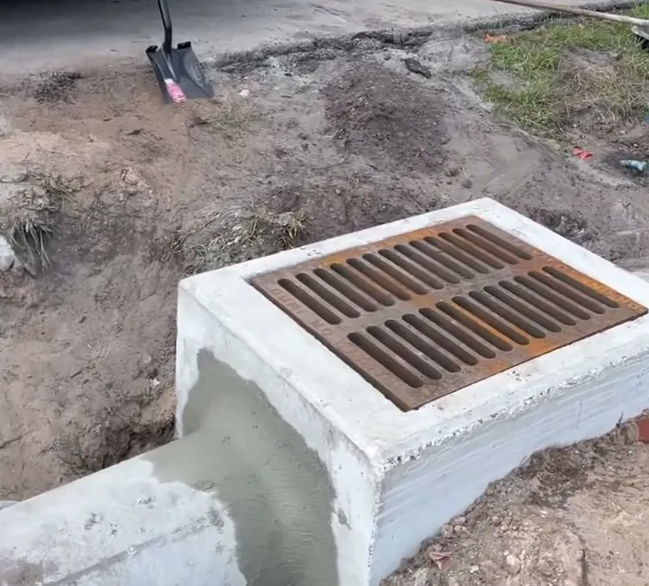 Concrete pipe grouted into a ditch-bottom drain inlet before the backfill goes in