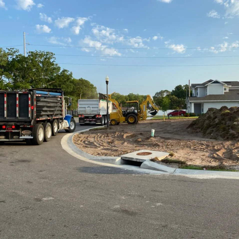 Dump trucks staged on the street at a site development job