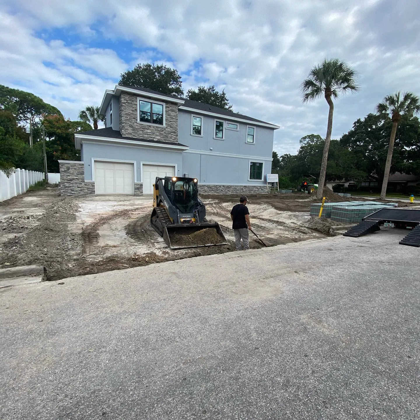 Skid steer working at a garage teardown site