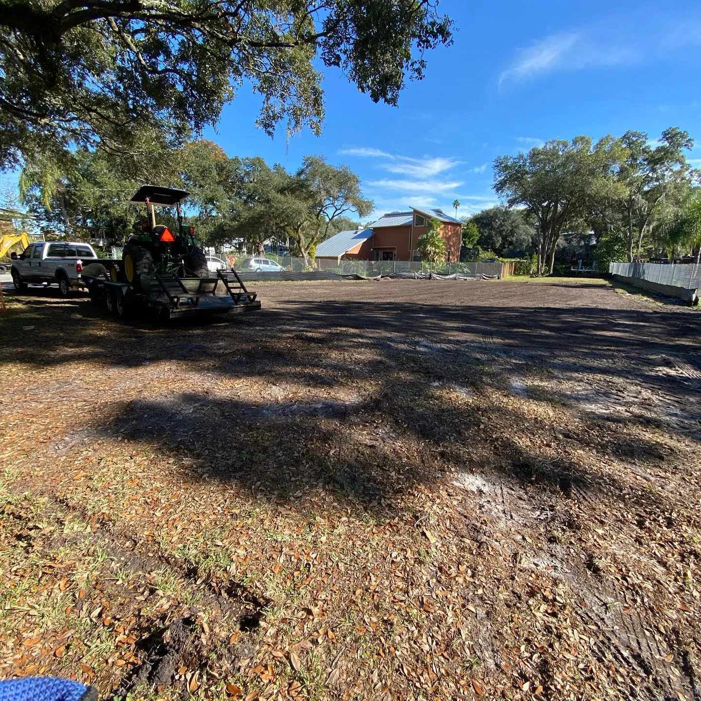 Residential lot freshly cleared and mulched down to dark bare soil