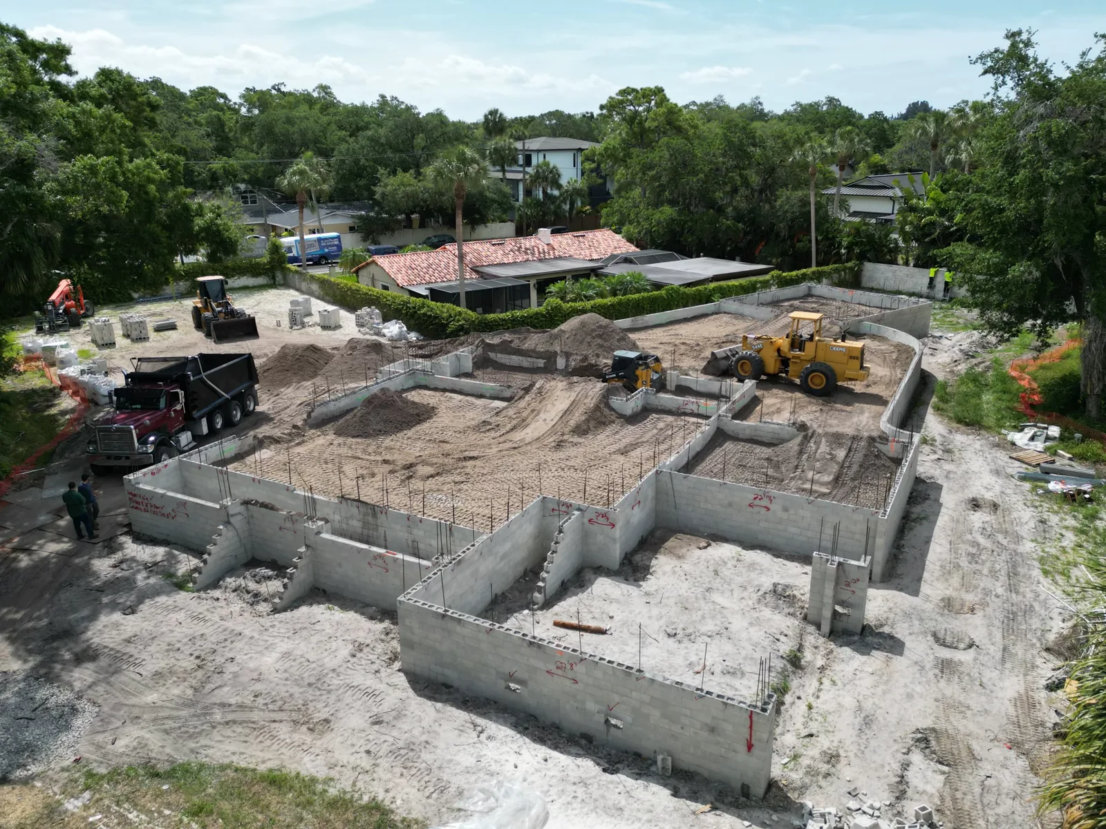 Aerial view of a CSD building pad with stem walls and equipment on a Tampa lot