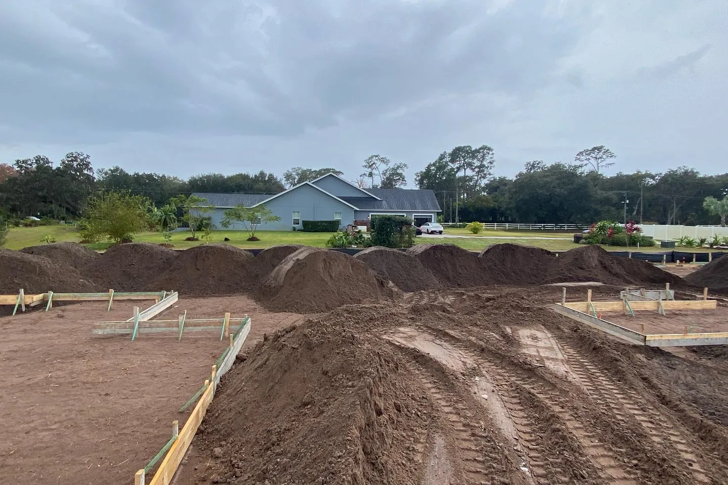 Cut and fill across a wide lot with form boards set for the pad