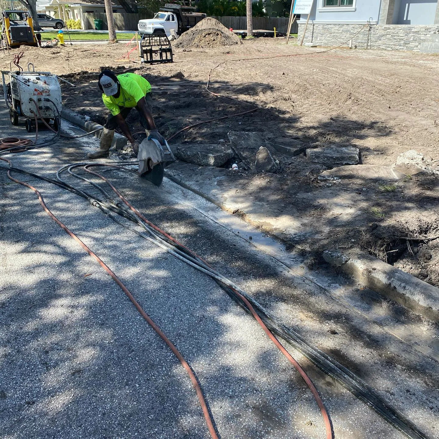 Utility and drainage lines laid out in trenches on a compacted pad