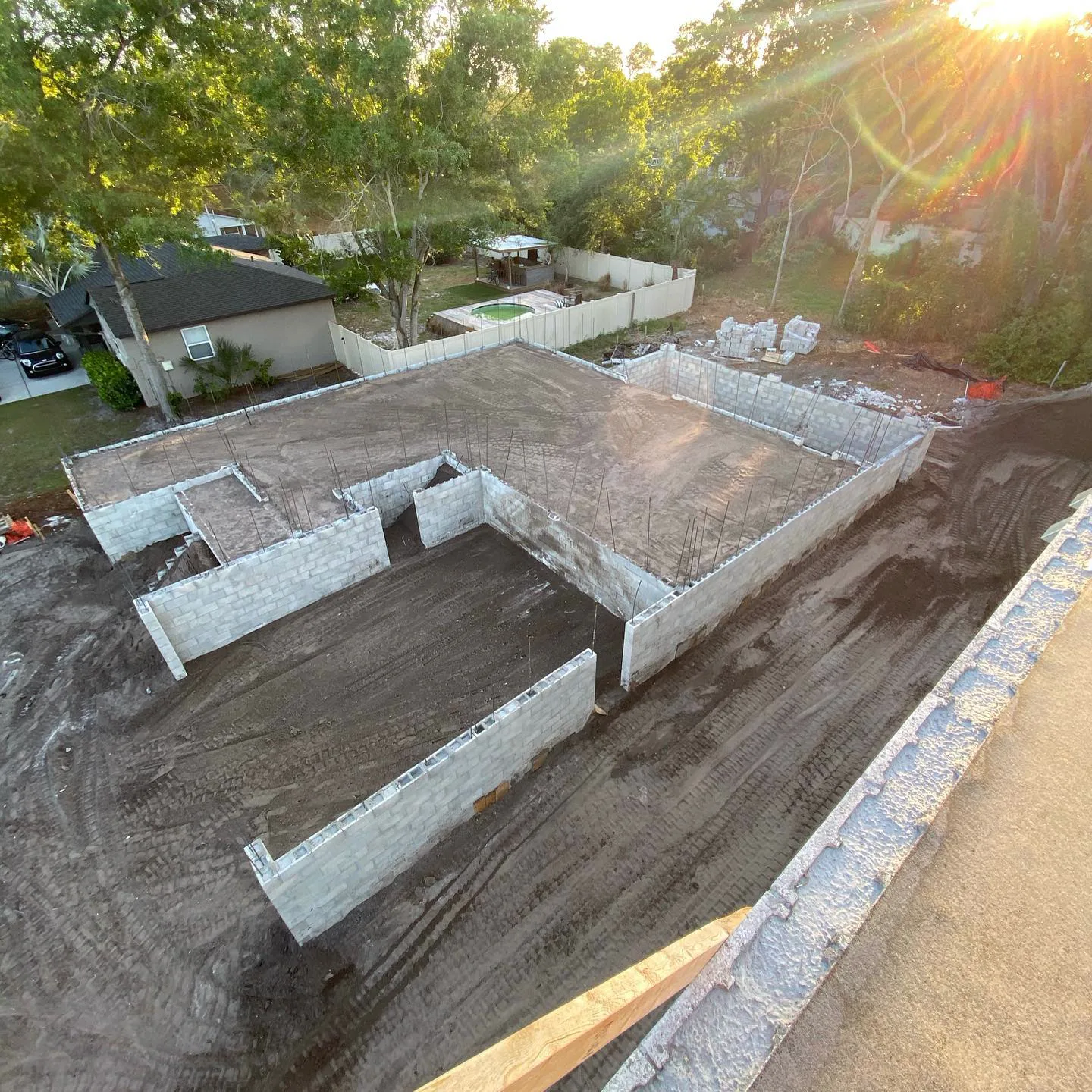 Stem wall building pad seen from above with fill staged